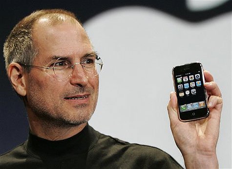 Steve Jobs shows the original iPhone.